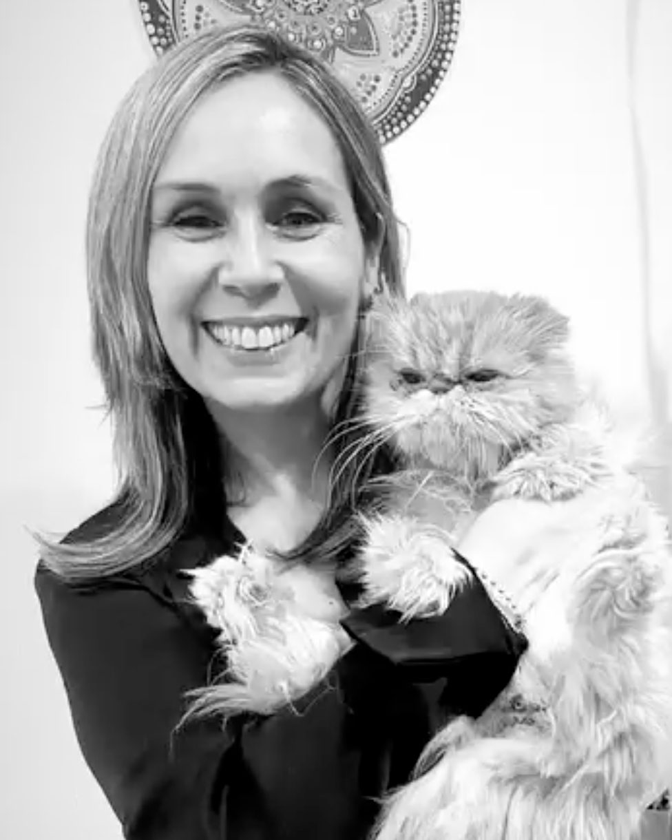 Retrato en blanco y negro de Ingrid Solís con su gato